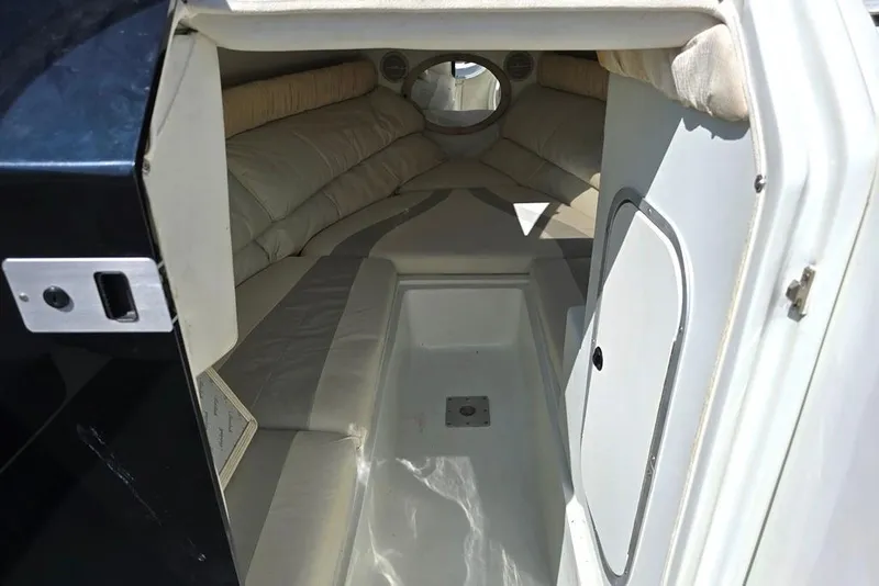 Slide: The Image of 1999 Mariah Shabah Z250 Cuddy Cabin interior with white seating and compact design. - 7