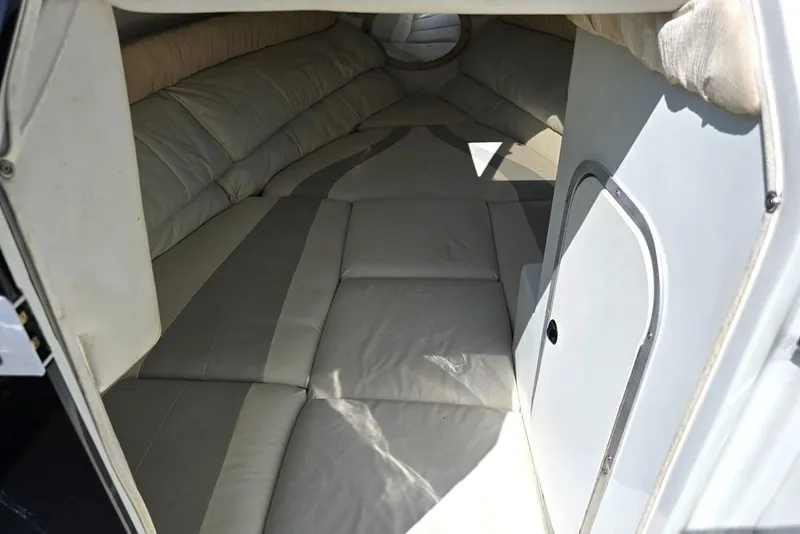 Slide: The Image of 1999 Mariah Shabah Z250 Cuddy Cabin interior with cushioned seating and compact design. - 8