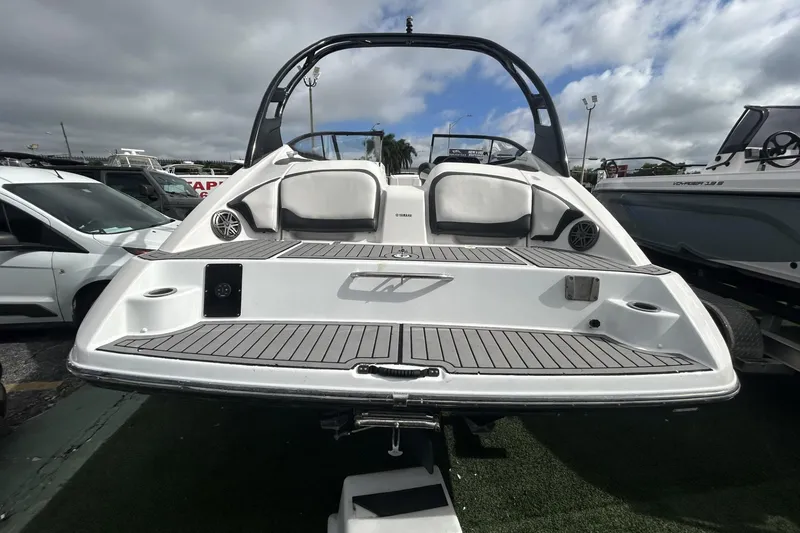 Slide: The Image of 2017 Yamaha Boats 212X, rear view, showcasing sleek design and spacious seating. - 6