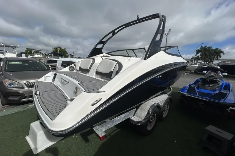 Slide: The Image of 2017 Yamaha Boats 212X on trailer, displayed outdoors under cloudy sky. - 8