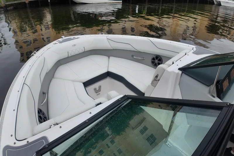 Slide: The Image of 2021 Regal LX2 boat interior with white seating and waterfront view. - 14