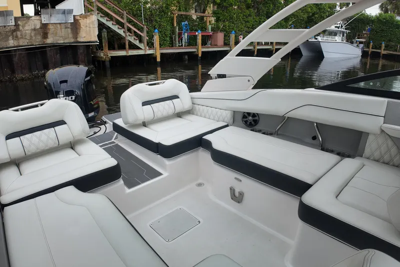 Slide: The Image of 2021 Regal LX2 boat interior with white seating and sleek design. - 17