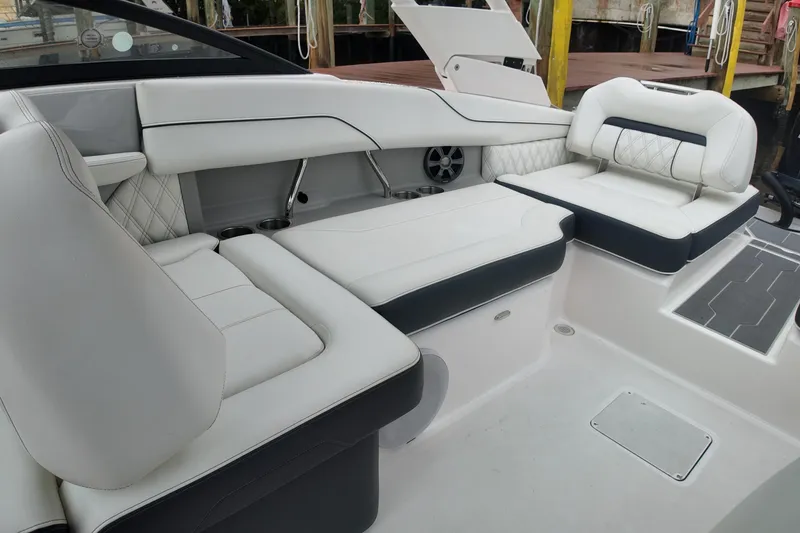 Slide: The Image of Luxurious seating area on a 2021 Regal LX2 boat, featuring elegant white upholstery. - 21