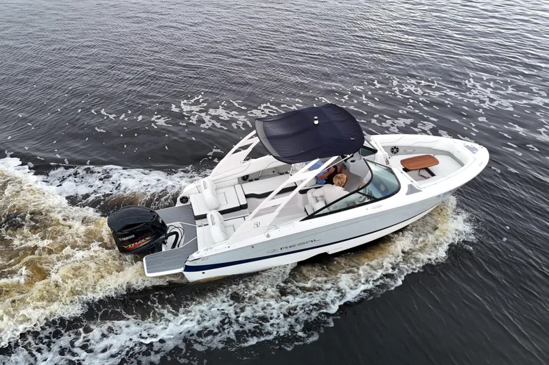 Slide: The Image of 2021 Regal LX2 boat cruising on water, aerial view, with Yamaha outboard motor. - 3