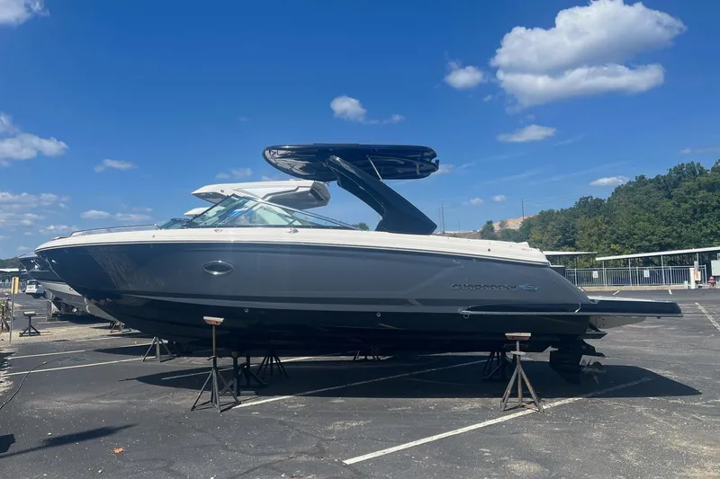 Slide: The Image of 2022 Chaparral 307 SSX boat on stands under a clear blue sky. - 15