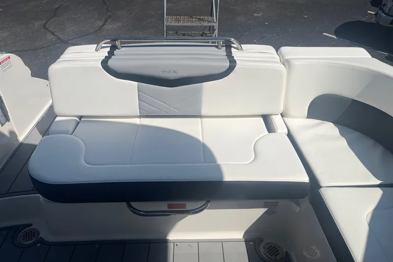 Slide: The Image of 2022 Chaparral 307 SSX boat interior with white cushioned seating. - 16