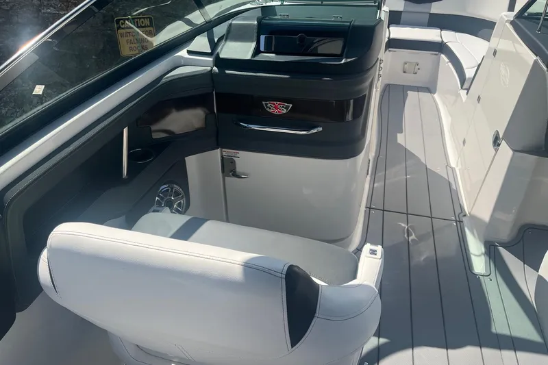 Slide: The Image of 2022 Chaparral 307 SSX boat interior with sleek seating and modern dashboard design. - 17