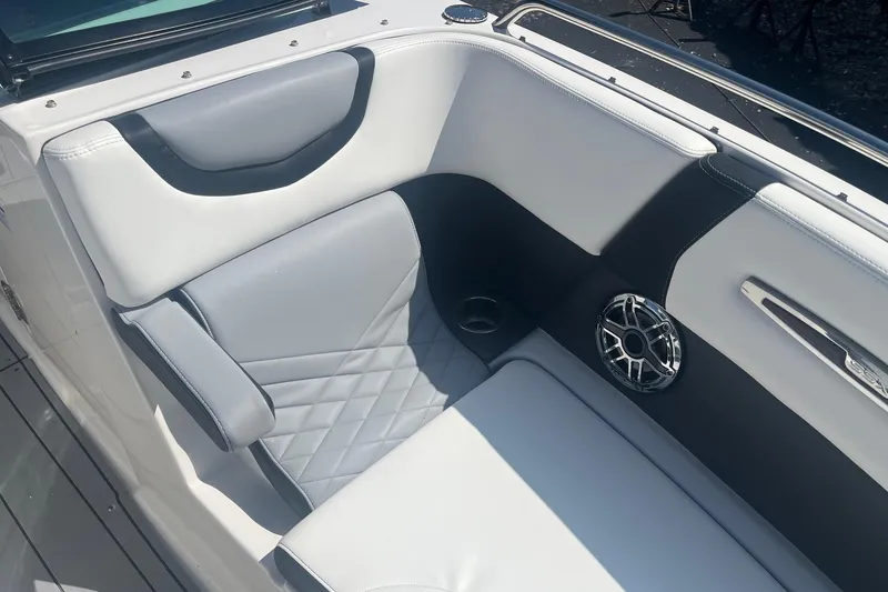 Slide: The Image of 2022 Chaparral 307 SSX boat interior with luxurious seating and speaker detail. - 3