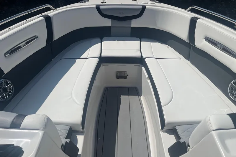 Slide: The Image of 2022 Chaparral 307 SSX boat interior with luxurious white seating and sleek design. - 4