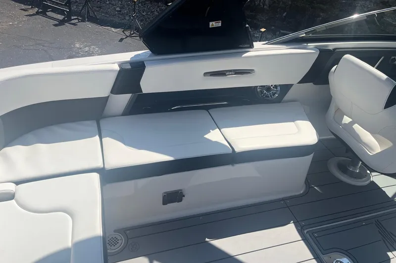 Slide: The Image of 2022 Chaparral 307 SSX boat interior with white seating and modern design. - 6
