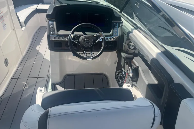 Slide: The Image of 2022 Chaparral 307 SSX boat cockpit with modern steering and controls. - 8