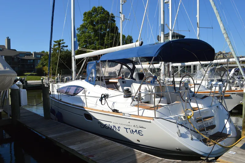 Slide: The Image of 2008 Jeanneau Sun Odyssey 45 DS sailboat docked, featuring blue canopy and sleek design. - 1