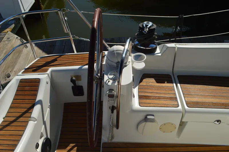 Slide: The Image of Cockpit of 2008 Jeanneau Sun Odyssey 45 DS with wooden deck and steering wheel. - 13