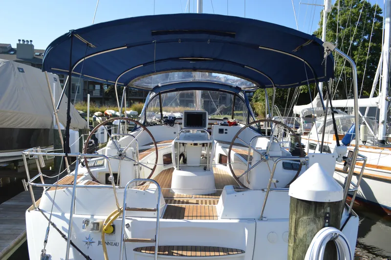 Slide: The Image of 2008 Jeanneau Sun Odyssey 45 DS sailboat with dual steering wheels and blue canopy. - 2