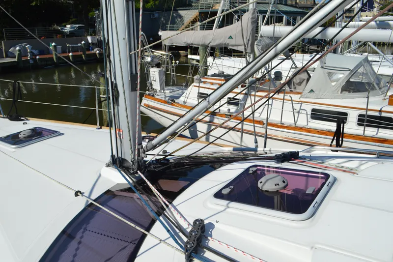 Slide: The Image of 2008 Jeanneau Sun Odyssey 45 DS sailboat deck with rigging and hatches in marina. - 22