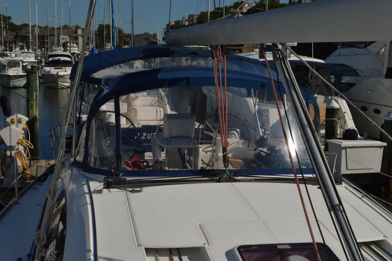 Slide: The Image of 2008 Jeanneau Sun Odyssey 45 DS sailboat docked in a marina, featuring a blue canopy. - 28