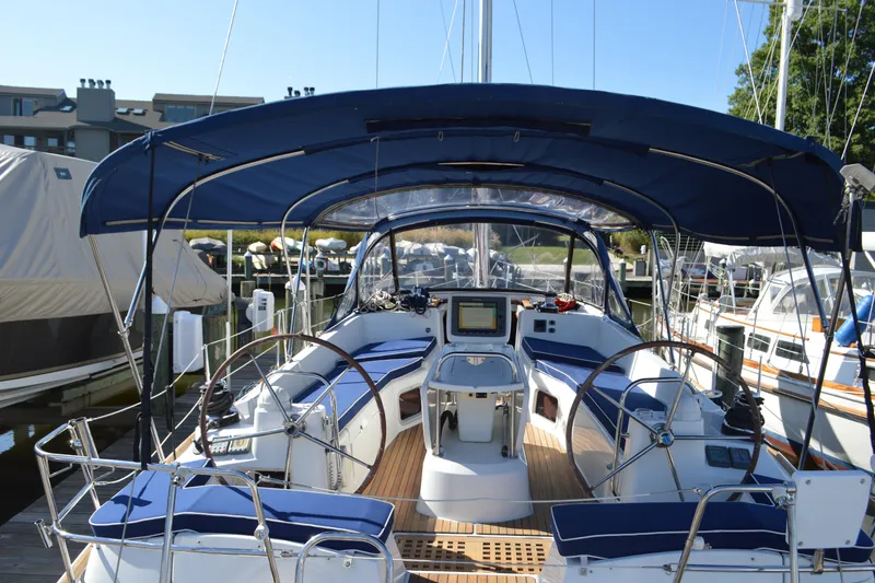 Slide: The Image of 2008 Jeanneau Sun Odyssey 45 DS sailboat with blue canopy docked at marina. - 36