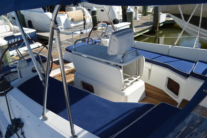 Slide: The Image of Cockpit of 2008 Jeanneau Sun Odyssey 45 DS with blue seating and wooden flooring. - 37