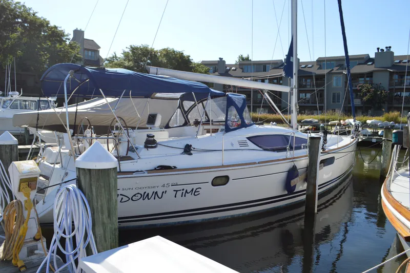 Slide: The Image of 2008 Jeanneau Sun Odyssey 45 DS sailboat docked at marina, surrounded by buildings. - 4
