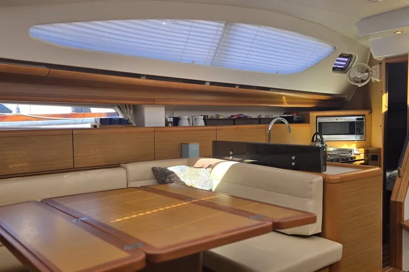 Slide: The Image of Luxurious interior of 2008 Jeanneau Sun Odyssey 45 DS yacht with modern kitchen and seating area. - 49