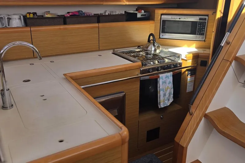 Slide: The Image of Galley kitchen in 2008 Jeanneau Sun Odyssey 45 DS sailboat with stove and microwave. - 50