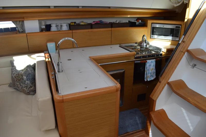 Slide: The Image of 2008 Jeanneau Sun Odyssey 45 DS yacht interior with modern kitchen and wooden cabinetry. - 51