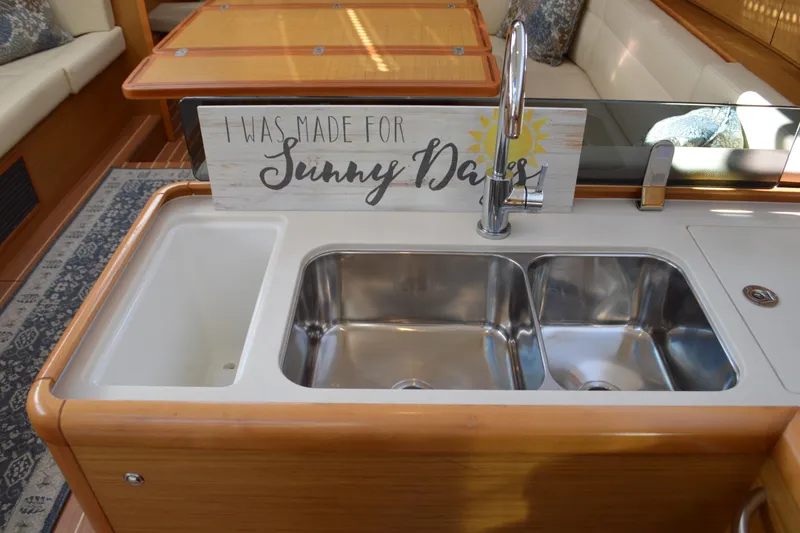 Slide: The Image of Galley sink area in 2008 Jeanneau Sun Odyssey 45 DS yacht with decorative sign. - 54