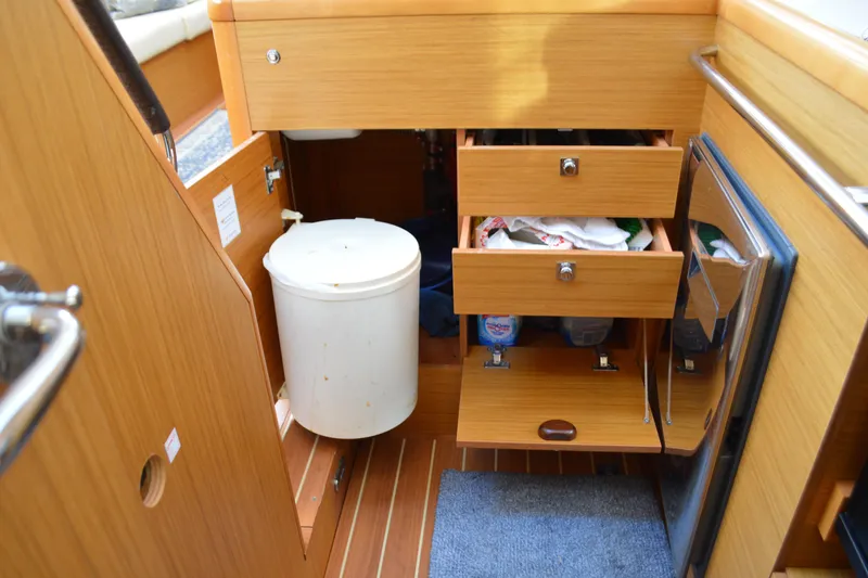 Slide: The Image of Interior of 2008 Jeanneau Sun Odyssey 45 DS yacht with wooden cabinetry and storage drawers. - 55