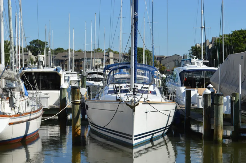 Slide: The Image of 2008 Jeanneau Sun Odyssey 45 DS sailboat docked in a marina, surrounded by other boats. - 6