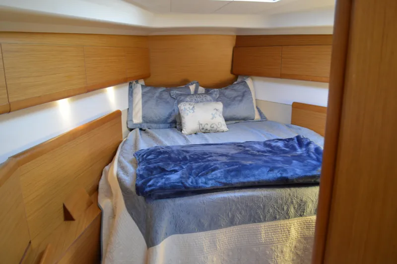 Slide: The Image of Cozy cabin interior of 2008 Jeanneau Sun Odyssey 45 DS with blue bedding. - 63