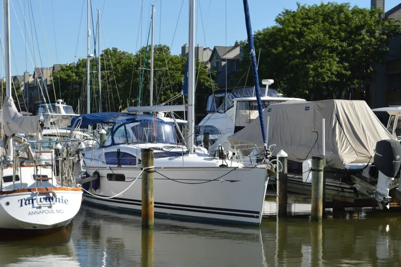 Slide: The Image of 2008 Jeanneau Sun Odyssey 45 DS sailboat docked in a marina, surrounded by other boats. - 7