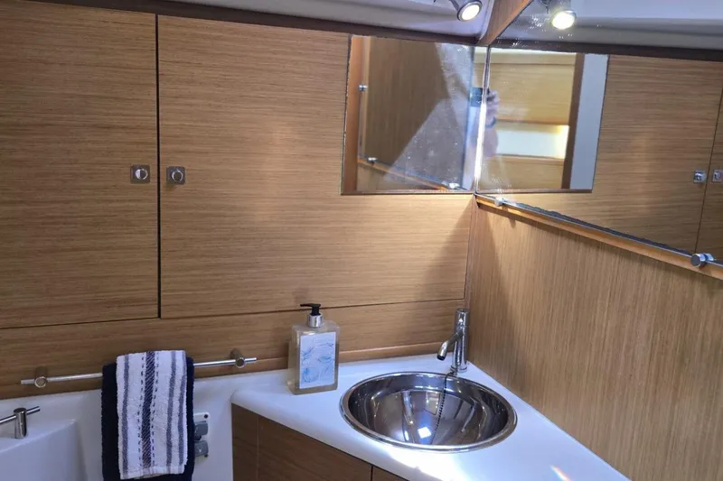 Slide: The Image of Luxurious bathroom in 2008 Jeanneau Sun Odyssey 45 DS yacht with wood finish and modern fixtures. - 71