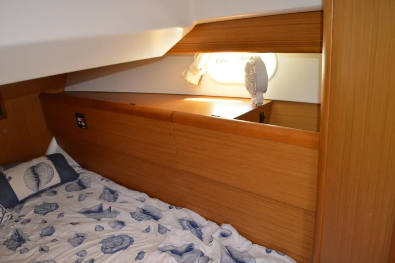 Slide: The Image of Cozy cabin interior of 2008 Jeanneau Sun Odyssey 45 DS with nautical-themed bedding. - 77
