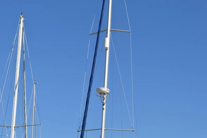 Slide: The Image of Masts of a 2008 Jeanneau Sun Odyssey 45 DS sailboat against a clear blue sky. - 8