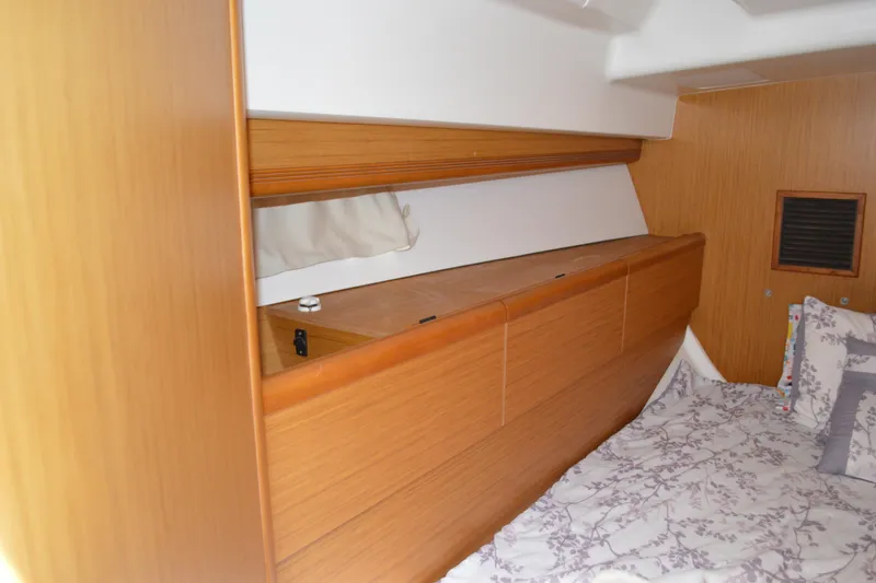 Slide: The Image of Interior cabin of 2008 Jeanneau Sun Odyssey 45 DS with wooden storage and bedding. - 80