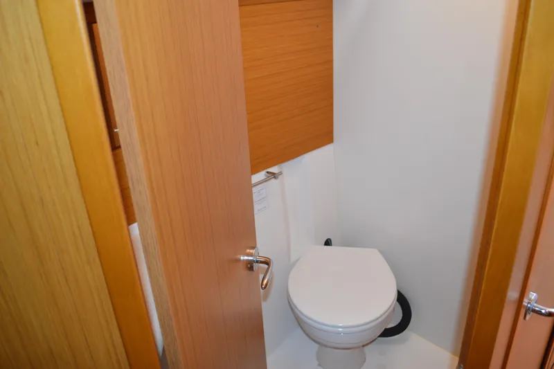 Slide: The Image of 2008 Jeanneau Sun Odyssey 45 DS yacht bathroom with wooden door and white toilet. - 81