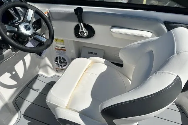 Slide: The Image of 2026 Chaparral 21 SSi boat interior with white seating and steering wheel. - 16