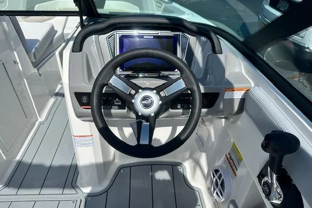 Slide: The Image of 2026 Chaparral 21 SSi boat dashboard with steering wheel and control panel. - 17