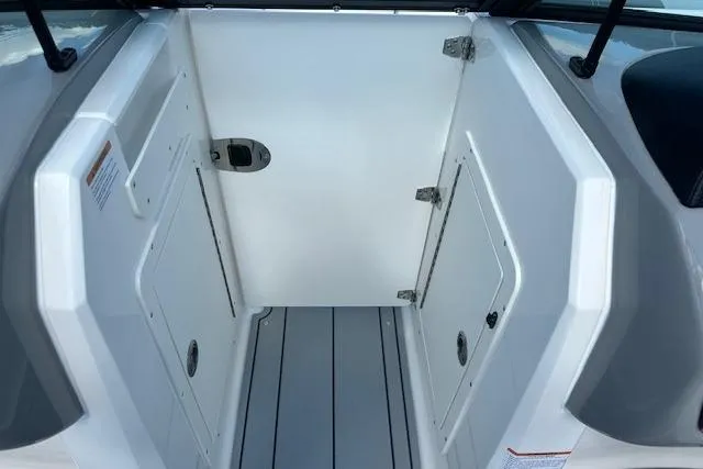 Slide: The Image of 2026 Chaparral 21 SSi boat interior with storage compartments and sleek design. - 21