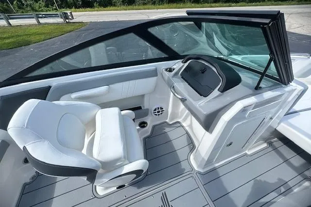 Slide: The Image of 2026 Chaparral 21 SSi boat interior with white seating and modern dashboard design. - 28