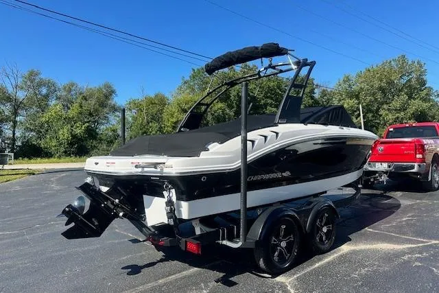 Slide: The Image of 2026 Chaparral 21 SSi boat on trailer, parked outdoors, with a red truck nearby. - 38