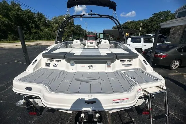 Slide: The Image of 2026 Chaparral 21 SSi boat, rear view, parked outdoors on a sunny day. - 7
