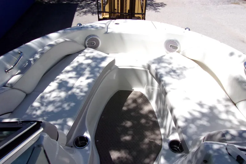 Slide: The Image of 2012 Sea Ray 200 Sundeck interior with white seating and cup holders. - 10