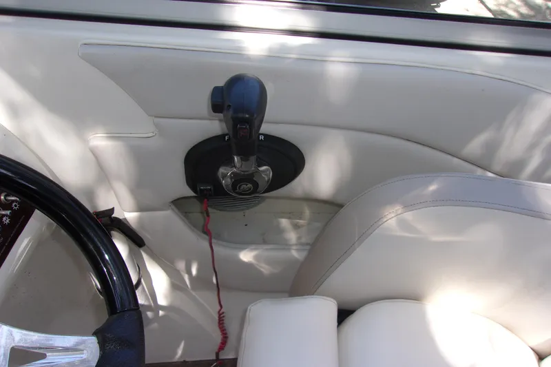 Slide: The Image of 2012 Sea Ray 200 Sundeck boat interior with steering wheel and throttle control. - 12