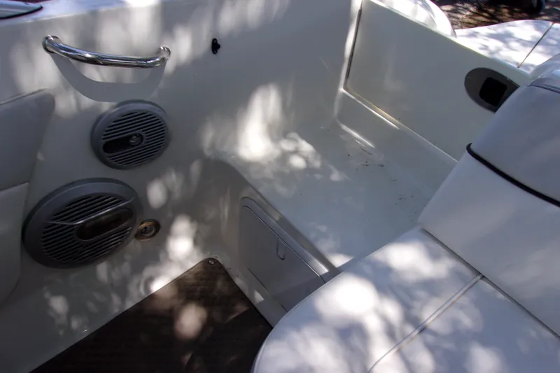 Slide: The Image of Interior of 2012 Sea Ray 200 Sundeck boat with seating and speakers. - 13
