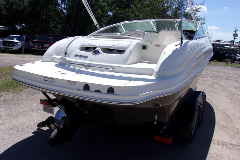 Slide: The Image of 2012 Sea Ray 200 Sundeck boat on trailer, rear view in outdoor setting. - 4