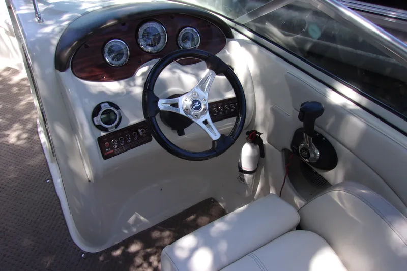 Slide: The Image of 2012 Sea Ray 200 Sundeck boat dashboard with steering wheel and controls. - 5