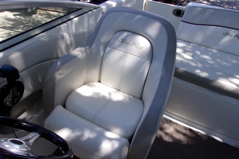 Slide: The Image of 2012 Sea Ray 200 Sundeck interior with white leather seating and steering wheel. - 6