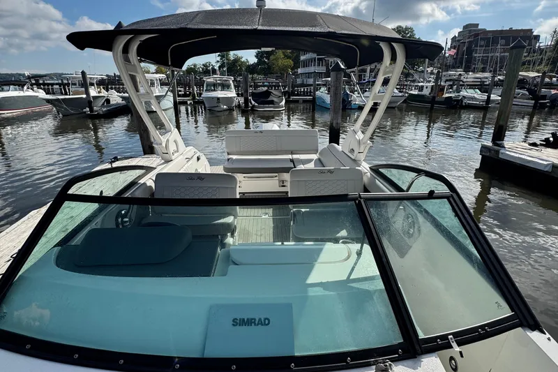 Slide: The Image of 2025 Sea Ray SDX 250 Outboard boat docked at marina, featuring sleek design and spacious seating. - 10