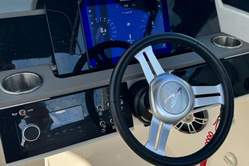 Slide: The Image of Steering wheel and dashboard of 2025 Sea Ray SDX 250 Outboard boat. - 11